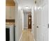 Hallway with wood-look floors, white walls, and a grandfather clock near the end at 8218 San Carlos Ct, Indianapolis, IN 46256