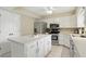 Bright kitchen features stainless steel appliances, white cabinets and a center island at 8218 San Carlos Ct, Indianapolis, IN 46256