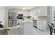 Well-lit kitchen offers white cabinets, stainless steel appliances, and center island at 8218 San Carlos Ct, Indianapolis, IN 46256