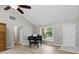 Inviting living room with a vaulted ceiling, wood floors, and large windows at 8218 San Carlos Ct, Indianapolis, IN 46256