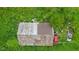 Overgrown lawn shows a dilapidated building surrounded by greenery at 8293 Water St, Coatesville, IN 46121