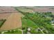 Expansive aerial view showcasing a large rural property with fields and a tree-lined driveway at 8293 Water St, Coatesville, IN 46121