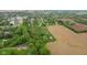 An aerial image highlighting the home's proximity to green space, farmland, and neighboring residences with a quaint road at 8293 Water St, Coatesville, IN 46121