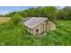 Overgrown barn shows weathered exterior and rural setting at 8293 Water St, Coatesville, IN 46121
