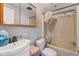 Compact bathroom with a sink, toilet, and shower-tub combination featuring dated fixtures and worn conditions at 8293 Water St, Coatesville, IN 46121