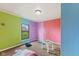 A bedroom with multi-colored paneled walls, basic carpeting, and minimal furnishings at 8293 Water St, Coatesville, IN 46121