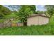 Overgrown back of building shows fenced in area at 8293 Water St, Coatesville, IN 46121