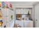 Shows a cluttered laundry area with a washer, dryer, refrigerator, and various household items piled around at 8293 Water St, Coatesville, IN 46121