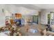 A view of the combined living room and kitchen space with light streaming through the windows at 8293 Water St, Coatesville, IN 46121