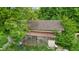 Rustic shed with chicken coop showcases its potential within a lush, overgrown landscape at 8293 Water St, Coatesville, IN 46121