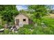 Weathered shed with an overgrown yard, featuring additional structures and potential at 8293 Water St, Coatesville, IN 46121