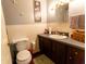 Cozy bathroom with wood-look flooring, grey walls, and decorative fixtures at 8362 Punto Alto Dr, Indianapolis, IN 46227