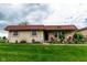 Charming single-story home with a red tile roof and a well-manicured green lawn at 8362 Punto Alto Dr, Indianapolis, IN 46227