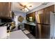 Compact kitchen featuring stainless steel appliances, dark wood cabinets, and modern flooring at 8362 Punto Alto Dr, Indianapolis, IN 46227