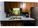 Practical kitchen with ample counter space, dark wood cabinets, and a stainless steel sink at 8362 Punto Alto Dr, Indianapolis, IN 46227