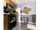 Modern kitchen with dark cabinetry, black appliances, and a unique washer/dryer setup for convenience at 8362 Punto Alto Dr, Indianapolis, IN 46227