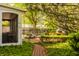 Beautifully landscaped backyard with a brick pathway, manicured hedges, and a screened-in porch at 8770 N Pennsylvania St, Indianapolis, IN 46240
