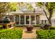 Charming backyard patio with an outdoor grill, a fire pit, and access to the screened-in porch at 8770 N Pennsylvania St, Indianapolis, IN 46240