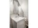 Stylish bathroom with a gray vanity, white sink, and unique patterned wallpaper at 8770 N Pennsylvania St, Indianapolis, IN 46240