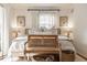 Bright bedroom with a comfortable bed, decorative pillows, and a wooden bench at 8770 N Pennsylvania St, Indianapolis, IN 46240