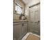 Charming entryway with grey cabinetry, unique window, and a decorative floral arrangement at 8770 N Pennsylvania St, Indianapolis, IN 46240