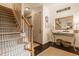 Elegant foyer featuring hardwood floors, staircase, and a decorative console table with stylish accents at 8770 N Pennsylvania St, Indianapolis, IN 46240