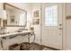 Bright entryway with stained glass window, table, basket, and ornate mirror, for a classic look at 8770 N Pennsylvania St, Indianapolis, IN 46240