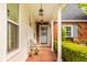 Inviting front porch with cozy seating, elegant lighting, and brick accents, perfect for relaxing at 8770 N Pennsylvania St, Indianapolis, IN 46240