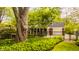 Charming home with a well-manicured front yard, a brick fence, and lush landscaping at 8770 N Pennsylvania St, Indianapolis, IN 46240