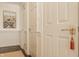 Hallway with white closet doors and walls and a decorative tassel on the door handle at 8770 N Pennsylvania St, Indianapolis, IN 46240