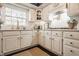 Bright, functional kitchen with white cabinetry, marble countertops, gold hardware, and modern appliances at 8770 N Pennsylvania St, Indianapolis, IN 46240