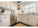 Elegant kitchen with white cabinets, stainless steel appliances, marble countertops, and modern fixtures at 8770 N Pennsylvania St, Indianapolis, IN 46240