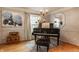 Elegant living room with a piano, chandelier, and beautiful painting creates a warm and inviting space at 8770 N Pennsylvania St, Indianapolis, IN 46240