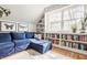Bright living room with comfortable blue couch, built-in bookshelves, and hardwood floors at 8770 N Pennsylvania St, Indianapolis, IN 46240
