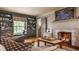 Cozy living room with fireplace, built-in bookshelves, and a comfortable window seat at 8770 N Pennsylvania St, Indianapolis, IN 46240