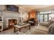 Bright living room with stone fireplace, wood armoire, and exposed brick at 8770 N Pennsylvania St, Indianapolis, IN 46240