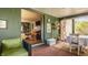 Inviting sunroom with brick flooring, green accents, and open view into a comfortable living space at 8770 N Pennsylvania St, Indianapolis, IN 46240