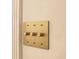 Close-up shot of sophisticated, gold-toned lighting control panel and dimmer switch on a neutral wall at 8770 N Pennsylvania St, Indianapolis, IN 46240