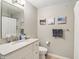 Well-lit bathroom featuring a granite vanity and decorative mirror at 8910 Hunters Creek Dr # 207, Indianapolis, IN 46227
