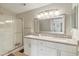 Bathroom featuring a glass shower, double vanity, and modern fixtures at 8910 Hunters Creek Dr # 207, Indianapolis, IN 46227