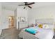 Cozy bedroom with neutral tones, ceiling fan, ensuite bathroom, and bright natural light at 8910 Hunters Creek Dr # 207, Indianapolis, IN 46227