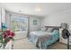 Bedroom featuring a large window, carpet, flowers, and neutral decor at 8910 Hunters Creek Dr # 207, Indianapolis, IN 46227