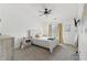Bright bedroom features a ceiling fan, carpeted floor, and a comfy bed near the window at 8910 Hunters Creek Dr # 207, Indianapolis, IN 46227