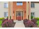 Close up view of condominium entrance with brick facade and neatly manicured shrubs at 8910 Hunters Creek Dr # 207, Indianapolis, IN 46227