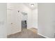 Hallway with neutral walls and carpet, showing access to the office area at 8910 Hunters Creek Dr # 207, Indianapolis, IN 46227