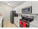 Kitchen with stainless steel appliances, white cabinets and a grey backsplash at 8910 Hunters Creek Dr # 207, Indianapolis, IN 46227