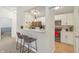 Cozy kitchen with a view into the dining and living areas, and bar stool seating at 8910 Hunters Creek Dr # 207, Indianapolis, IN 46227