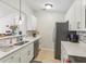 Well-lit kitchen features sleek, stainless steel appliances and modern white cabinetry at 8910 Hunters Creek Dr # 207, Indianapolis, IN 46227