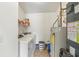 A tidy laundry room includes a washer, dryer, and water heater at 8910 Hunters Creek Dr # 207, Indianapolis, IN 46227