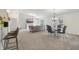 Open-concept living room with fireplace, dining space, and bar seating at the kitchen counter at 8910 Hunters Creek Dr # 207, Indianapolis, IN 46227